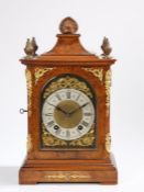 Victorian walnut mantel clock, the shell form pediment flanked by swirled brass finials, the