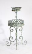 Painted metal plant stand, with two tiers with lattice bases above a scroll base, 43cm wide, 108cm
