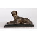 19th Century bronze dog, modelled in a laying position, on a black marble plinth base, 18cm wide,