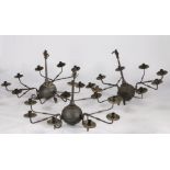 Three cast iron chandeliers, the bulbous bodies set with three detachable arms each with three