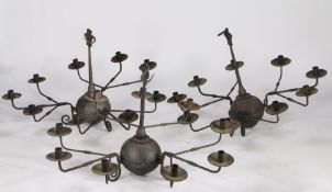 Three cast iron chandeliers, the bulbous bodies set with three detachable arms each with three