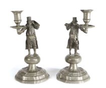 A pair of early 19th century pewter figural candlesticks, German In the manner of a