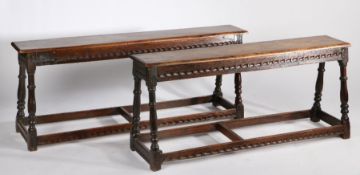 Near pair of 17th Century style oak benches, early elements, the rectangular tops above angled