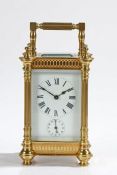 Late 19th Century French brass carriage clock, the reeded pilastered case with swing handle, the