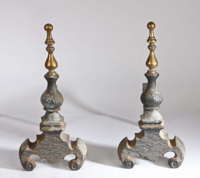 Pair of  brass and iron fire dogs, with final tops above an arched base with supports to the rear of
