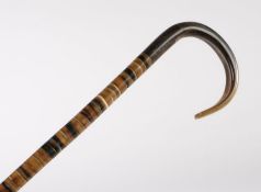 Walking stick with horn handle and cane formed from polished horn discs, 84.5cm long