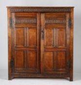 An oak enclosed cupboard, 17th Century elements, the rectangular top above a thumb moulded frieze