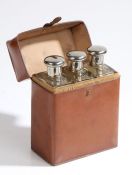 Three mid 20th Century spirit flasks, the chrome screw fitting caps opening to reveal glass