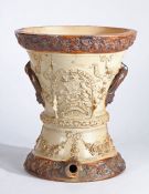 Victorian stoneware cistern or water filter, the tapering body with raised moulded foliate