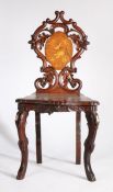 Late 19th Century Black Forest musical chair, the scroll and acorn carved back with a box wood