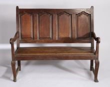George III oak settle, the four fielded panel back above a later solid seat flanked by curved arms