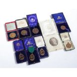 Collection of nine rifle shooting prize medallions, medals and badges, to include George V silver