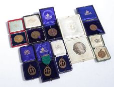 Collection of nine rifle shooting prize medallions, medals and badges, to include George V silver