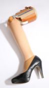 Ladies prosthetic leg, the leather and metal top section above a composite lower section, complete