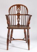 A mid-19th century yew, ash and elm Windsor armchair, North East Midlands, the hooped back above a