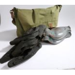 Eleven pigeon decoys and four crow decoys, housed in a green canvas game bag (qty)