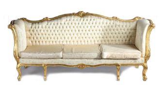 Continental gilt wood settee, with an undulating back carved with flowers above a button back and