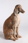 A terracotta statue of an Afghan Hound, in a seated position, 87cm high