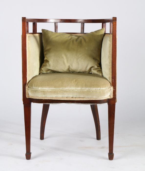 Edwardian mahogany tub chair, the curved open back raised on rectangular supports, with