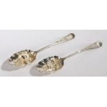 Two George III and later decorated berry spoons, with fruit embossed bowls and foliate decorated