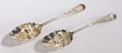 Two George III and later decorated berry spoons, with fruit embossed bowls and foliate decorated