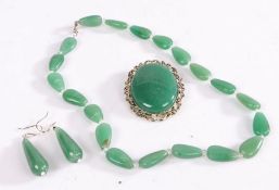 A set of white metal jade jewellery including a necklace, brooch and a pair of drop earrings.