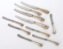 Set of six silver handled tea knives, with pistol grip handles, four similar table knives, the