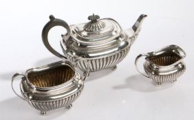 Silver plated three piece tea set, consisting of teapot with ebony handle and finial, milk jug and