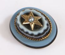 A late Victorian banded agate stick pin set with a pearl on a gold metal star. Approx.