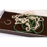 A pearl necklace, a green stone necklace and a single white metal earring. Encased in a box. Gross