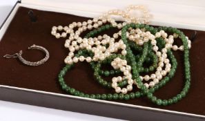 A pearl necklace, a green stone necklace and a single white metal earring. Encased in a box. Gross