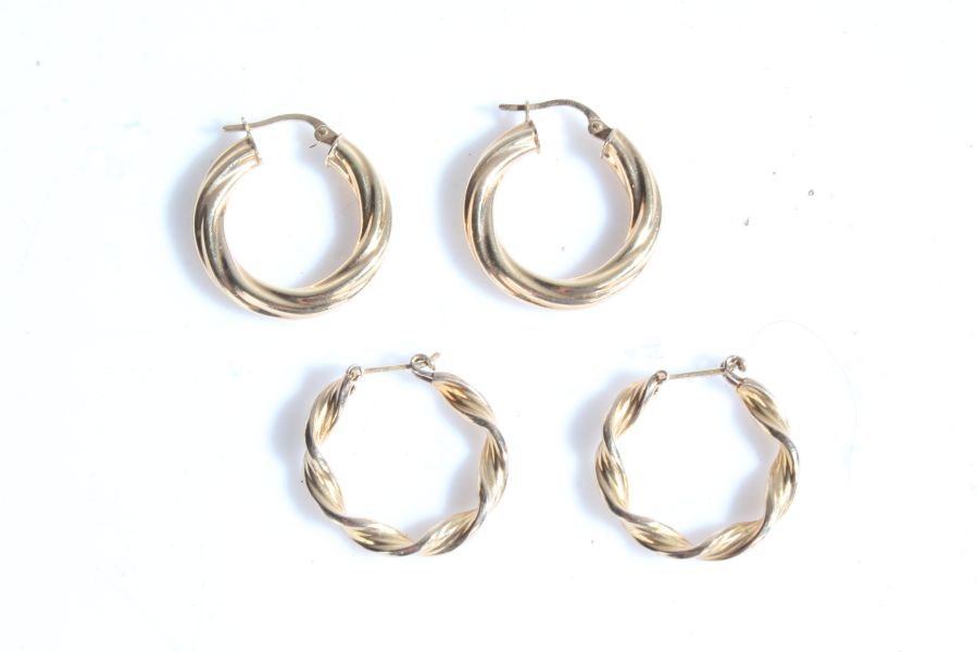 Two pairs of 9 carat gold loop earrings, one with a twist effect, weight 4.0 grams