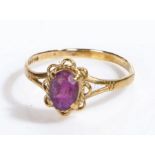 A 9 carat yellow gold ring set with one oval amethyst. Ring size O 1/2. Weighing 1.29 grams.