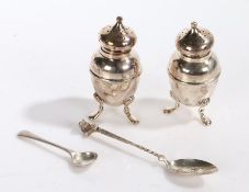 Pair of Edward VII silver pepperettes, London 1901, marks rubbed, each raised on three pad feet,