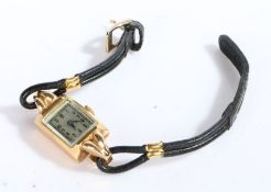 An 18 carat yellow gold ladies dress/cocktail watch with a black leather bracelet. Engraved on the