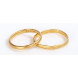 A pair of yellow gold rings with foreign markings. Assessed as 22 carat gold. Finger size M and K.