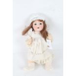 Paul Schmidt bisque headed doll, with long brown hair and white dress, 38cm long