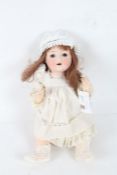 Paul Schmidt bisque headed doll, with long brown hair and white dress, 38cm long