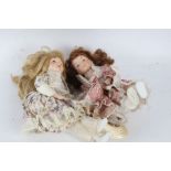 Two porcelain headed dolls, "The Classique Collection", each with floral dresses and hats (2)