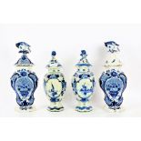 Two pairs of blue and white Delft style vase and covers, one pair with a hexagonal tapering body
