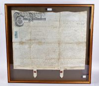 Two framed indentures, dated 1598 and 1704, in gilt glazed frames (2)