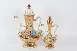 Two large gold lustre ware coffee pots, with the spout modeled as a swan with a bulbous gadrooned