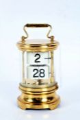 20th century brass cased perpetual calendar, of cylindrical form, 12.5cm high