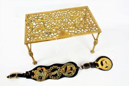 Brass trivet stand, with scenes of Medieval figures and animals, 35.5cm wide and a horse brass on