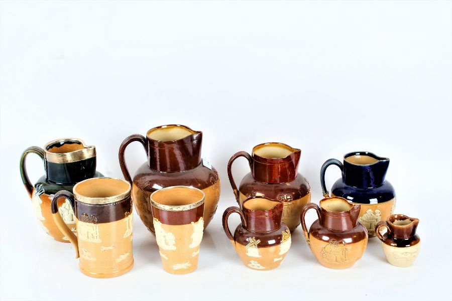 A Collection of nine Royal Doulton/ Doulton Lambeth stoneware jugs, three with silver rims some