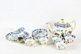 19th century porcelain part tea service, decorated in the Chinese manner, comprising tea pot, two