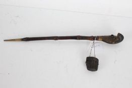 19th century opium pipe with a brass and foliate decorated end and a bamboo shaft, 44cm long