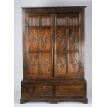 17th Century style oak enclosed cupboard, the cornice above long thumb moulded and lozenge carved