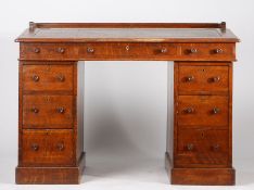 Victorian oak writing table, the tooled red leather inset writing slope opening to reveal a