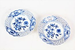 A pair of Meissen blue and white plates with a lattice pierced rim with a floral depiction to the